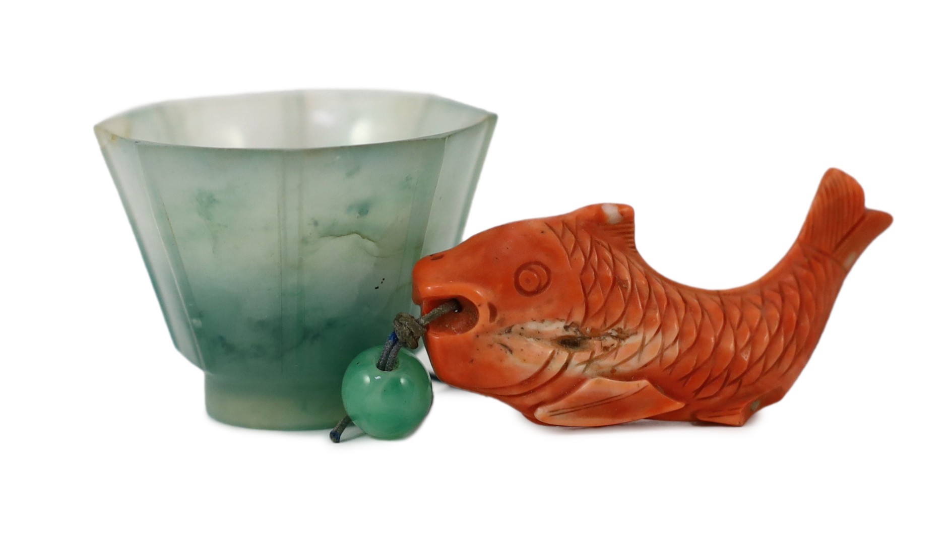 A Chinese jadeite small cup and a coral 'fish' pendant, 19th/20th century